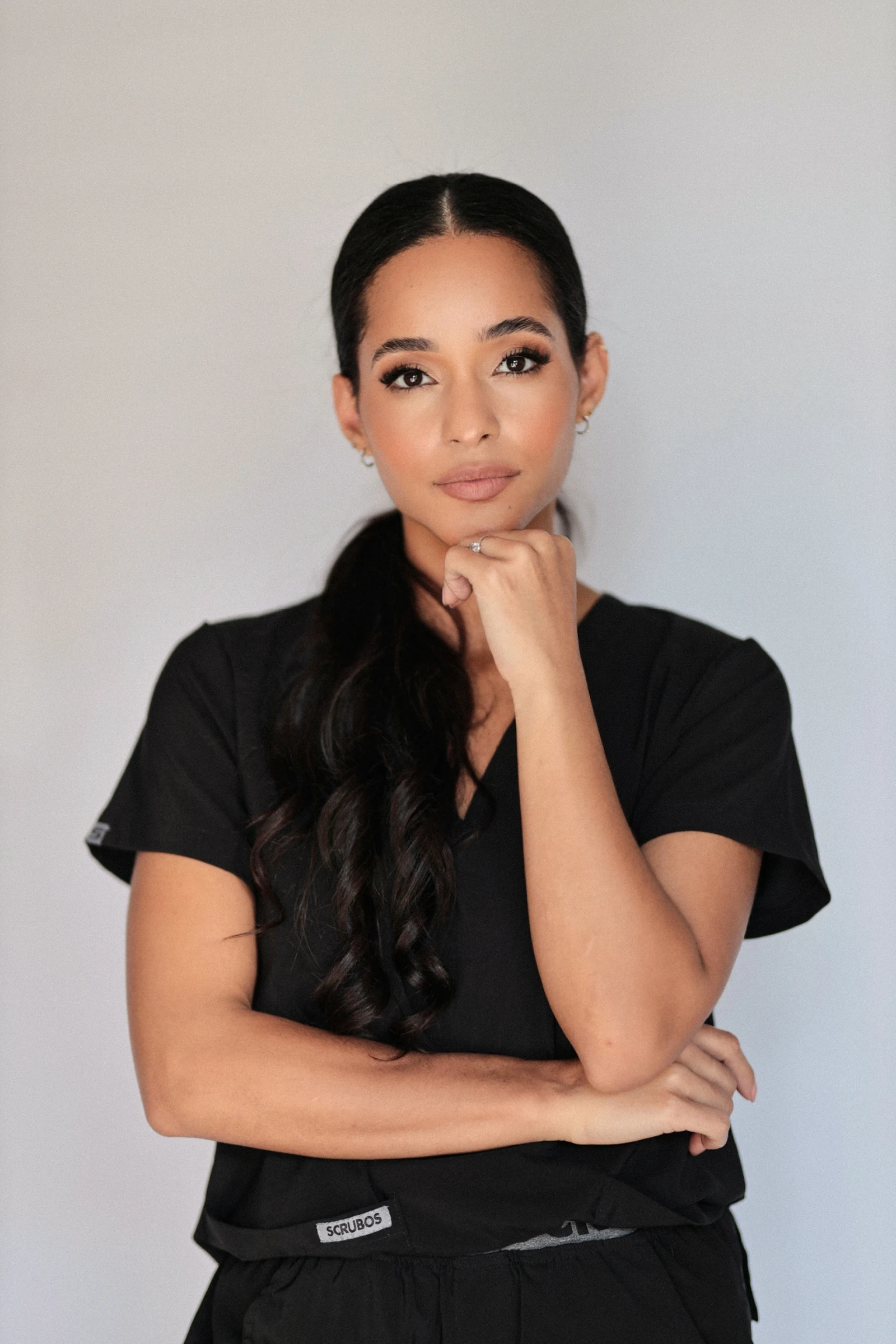 Dr Bello Alvarez in black medical scrubs